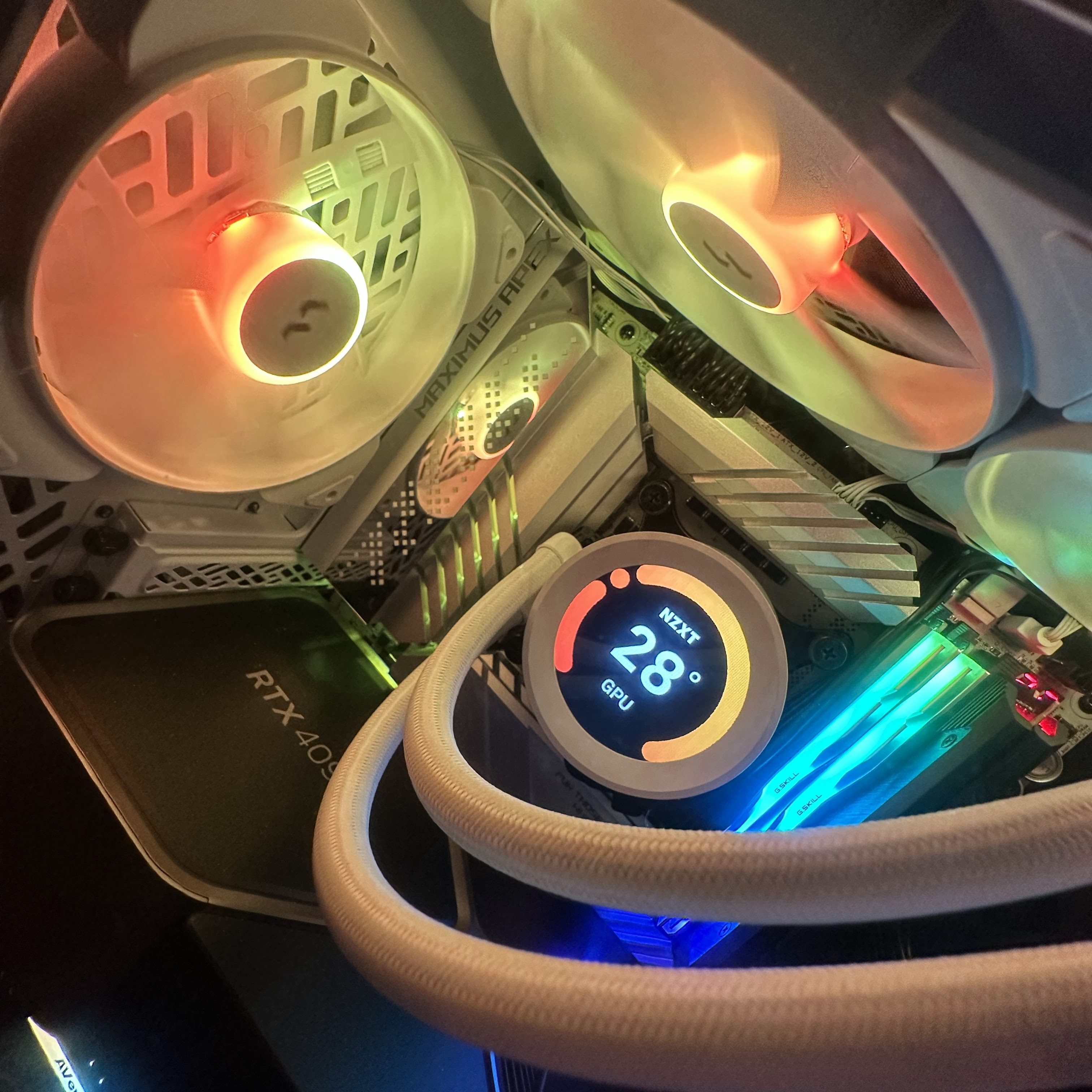 Image of the inside of a computer case, showing a pair of white fans that match, illuminated with tasteful RGB lights. 